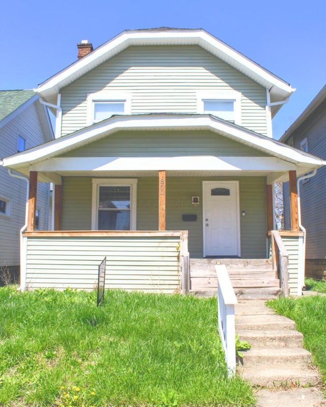 850 E Whittier St, Columbus, OH 43206 - view of front of house with a porch and a chimney