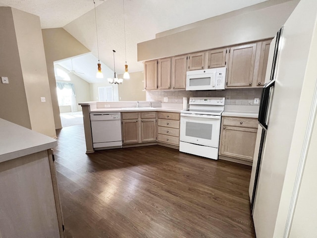 kitchen featuring sink, white appliances, hanging light fixtures, decorative backsplash, and vaulted ceiling