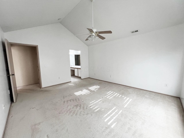 unfurnished bedroom featuring high vaulted ceiling, light colored carpet, and ceiling fan