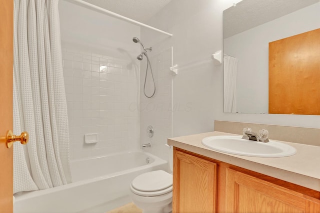 full bathroom with vanity, shower / tub combo, and toilet