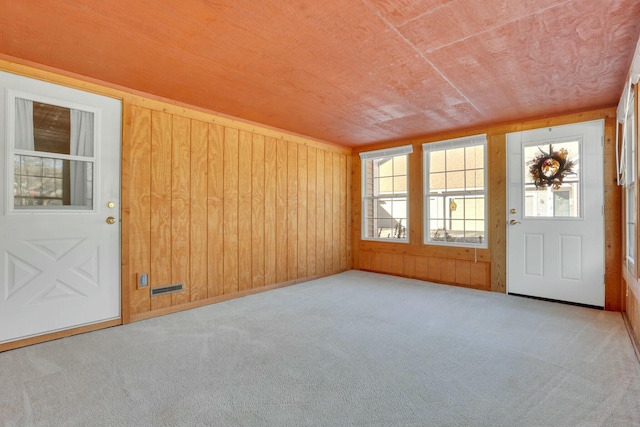 interior space with wood ceiling and wood walls