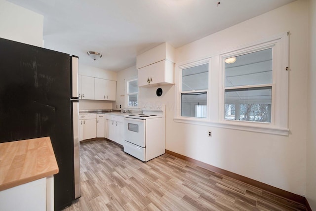 kitchen featuring sink, light wood-type flooring, white cabinetry, white electric stove, and stainless steel refrigerator