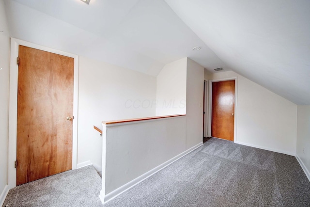 bonus room with carpet floors and vaulted ceiling