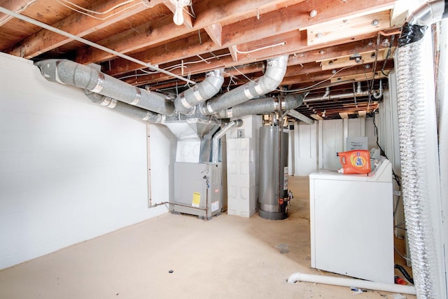 basement with heating unit, washer / dryer, and gas water heater