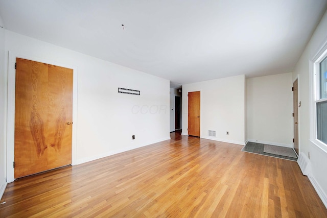 empty room with light hardwood / wood-style floors