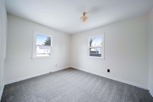 carpeted spare room featuring a wealth of natural light