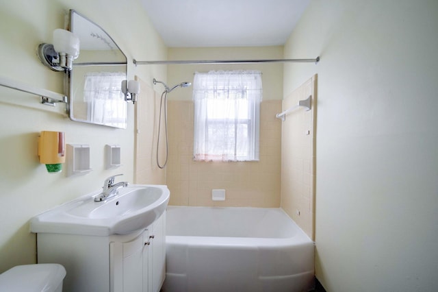 full bathroom with vanity, toilet, and tiled shower / bath