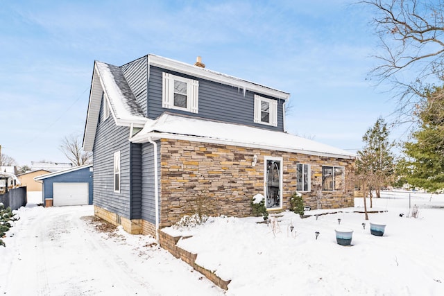 front of property with a garage and an outbuilding