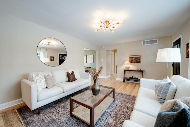 living room featuring hardwood / wood-style flooring and a chandelier