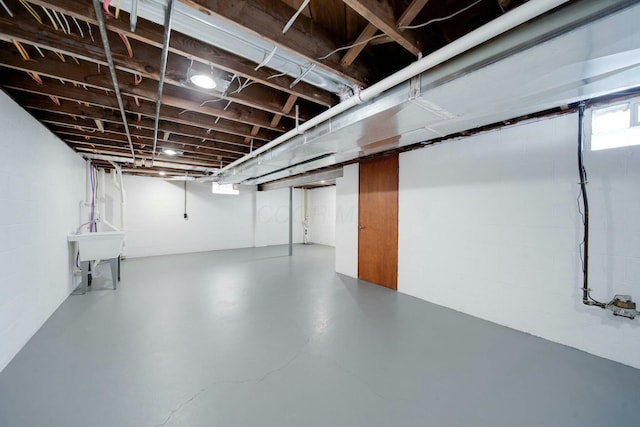 basement featuring plenty of natural light and sink