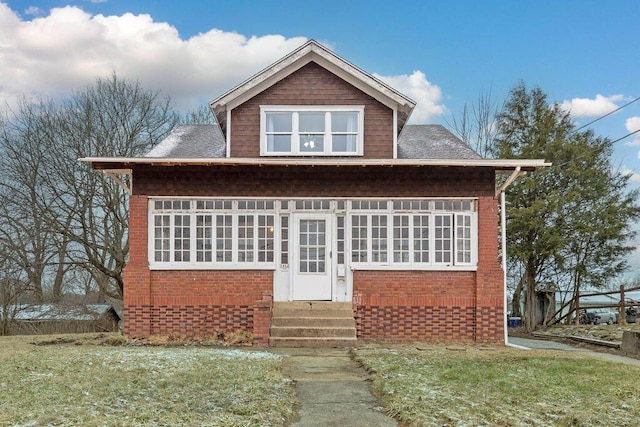 back of property featuring entry steps, roof with shingles, and brick siding