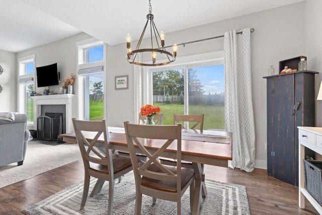 dining area with a notable chandelier and dark hardwood / wood-style floors