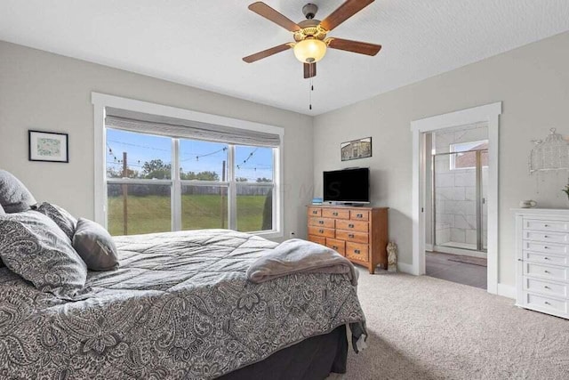 carpeted bedroom with ceiling fan, a textured ceiling, and ensuite bath