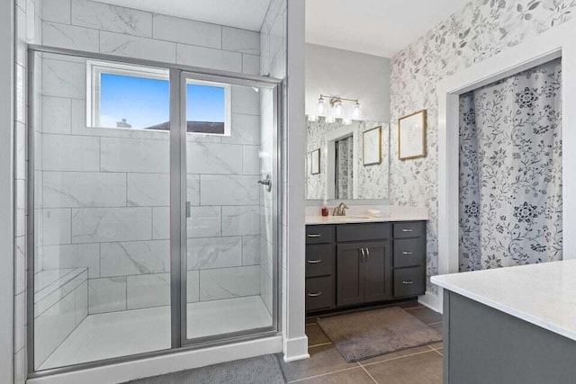 bathroom with tile patterned floors, a shower with door, and vanity