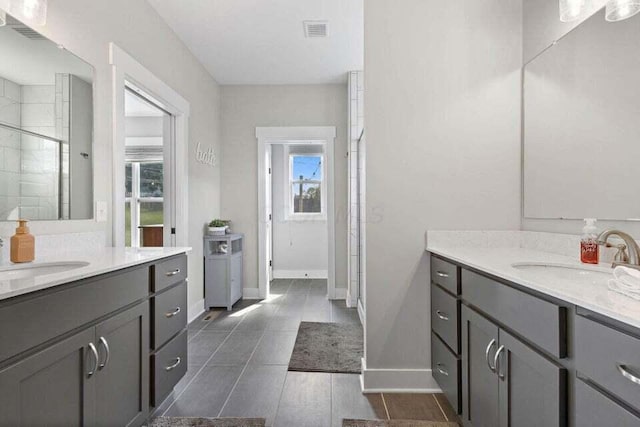 bathroom with a shower with door and vanity