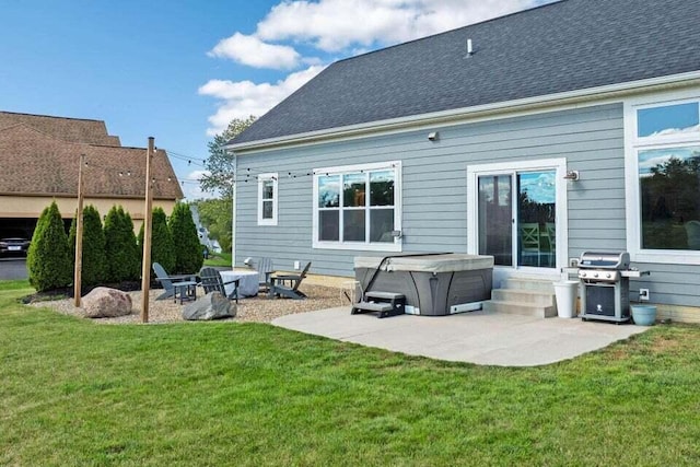 back of house with a patio, a hot tub, and a yard