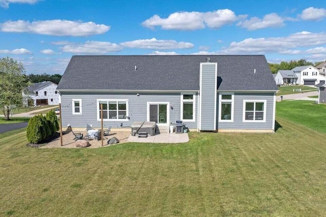 back of house with a patio area and a yard