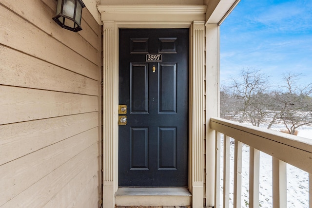 view of snow covered property entrance