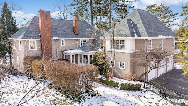 snow covered house with a garage