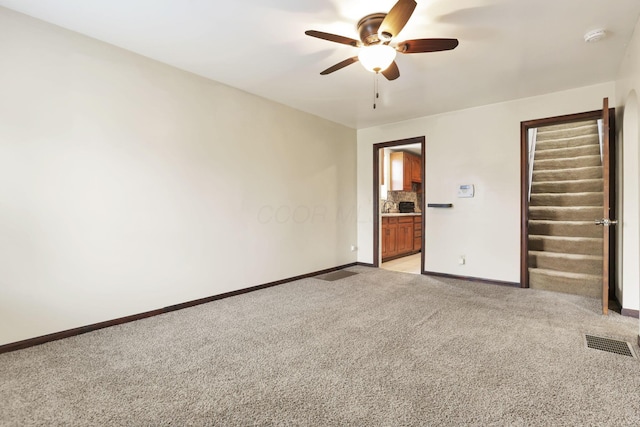1973 Dartmouth Ave, Columbus, OH 43219 - empty room featuring ceiling fan, light colored carpet, baseboards, and a smoke detector
