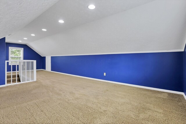 1973 Dartmouth Ave, Columbus, OH 43219 - additional living space featuring carpet floors, baseboards, lofted ceiling, a textured ceiling, and recessed lighting