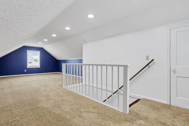 1973 Dartmouth Ave, Columbus, OH 43219 - additional living space with carpet floors, baseboards, vaulted ceiling, recessed lighting, and a textured ceiling