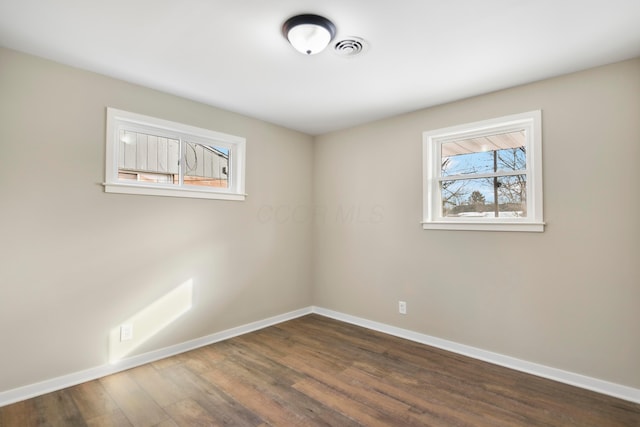 spare room featuring dark hardwood / wood-style floors