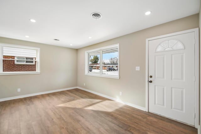 foyer entrance with visible vents, recessed lighting, baseboards, and wood finished floors