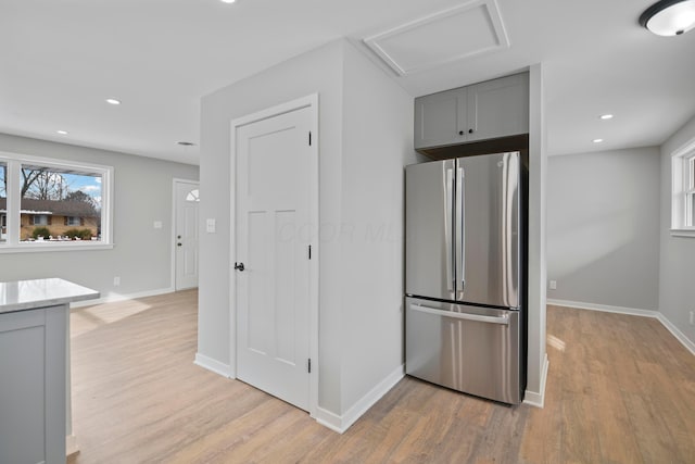 kitchen featuring light hardwood / wood-style floors, gray cabinets, and stainless steel refrigerator