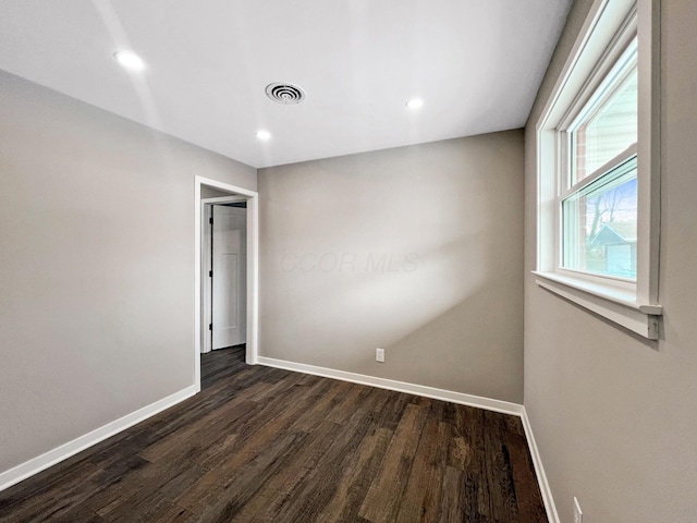 empty room with dark hardwood / wood-style floors