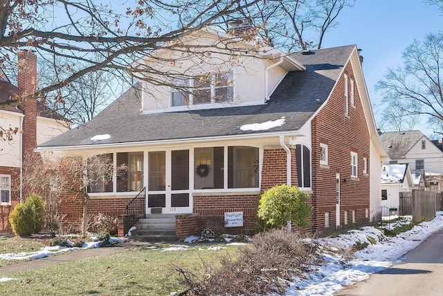 view of front of home featuring a sunroom