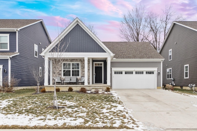 view of front of home with a garage and a porch