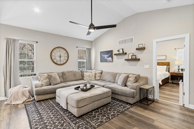 living room featuring lofted ceiling, wood-type flooring, and ceiling fan