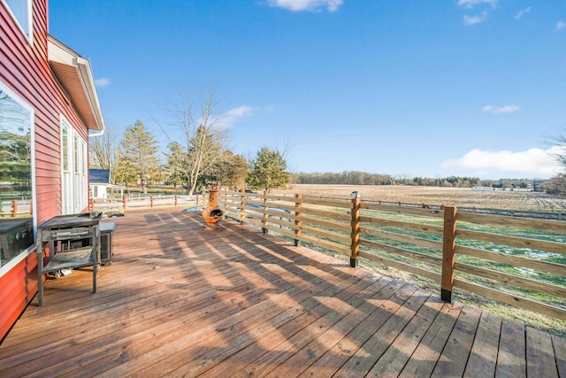 wooden deck with a rural view