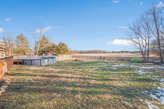 view of yard with a covered pool and a rural view