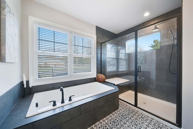 bathroom with shower with separate bathtub and tile patterned floors