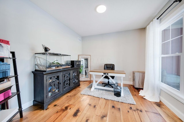 home office with hardwood / wood-style flooring