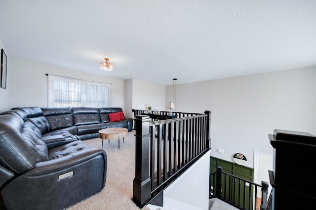 carpeted living room featuring a textured ceiling