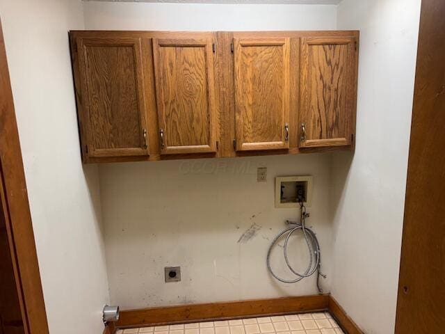 washroom with washer hookup, electric dryer hookup, and cabinets