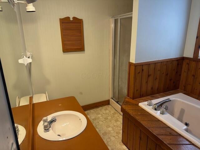 bathroom featuring sink and separate shower and tub