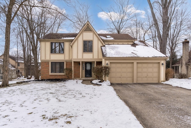 tudor-style house featuring a garage