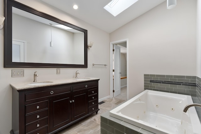 bathroom featuring a relaxing tiled tub, vanity, and lofted ceiling with skylight