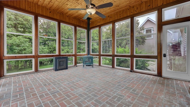 1859 Hardscrabble Rd, Alexandria, OH 43001 - unfurnished sunroom featuring a wood stove, wood ceiling, lofted ceiling, healthy amount of natural light, and wooden walls