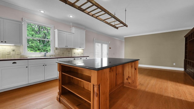 1859 Hardscrabble Rd, Alexandria, OH 43001 - kitchen featuring a sink, ornamental molding, light wood-type flooring, a kitchen island, and open shelves