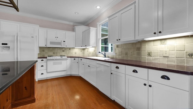 1859 Hardscrabble Rd, Alexandria, OH 43001 - kitchen with white appliances, a sink, ornamental molding, dark countertops, and light wood-type flooring
