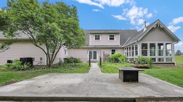 1859 Hardscrabble Rd, Alexandria, OH 43001 - back of property featuring a patio area, a sunroom, central AC, roof with shingles, and a fire pit