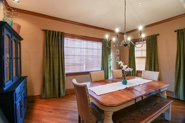 dining space with ornamental molding, plenty of natural light, and dark hardwood / wood-style floors