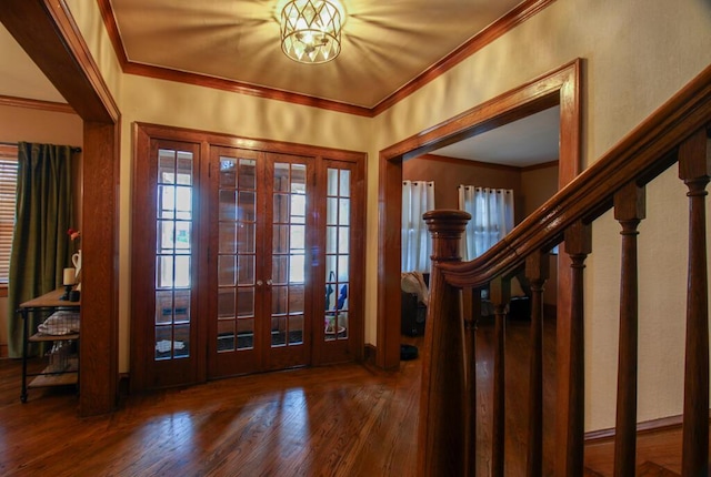 entryway featuring french doors, crown molding, and hardwood / wood-style flooring