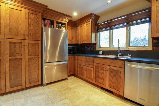 kitchen featuring tasteful backsplash, sink, and appliances with stainless steel finishes