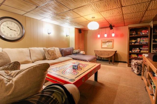 living room with light colored carpet and wood walls